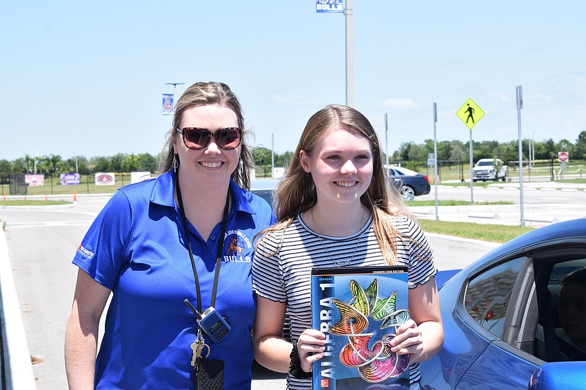 Lisa Webb, a senior secretary and bookkeeper at Mona Jain, celebrates her daughter Caitlyn graduating from eighth grade.