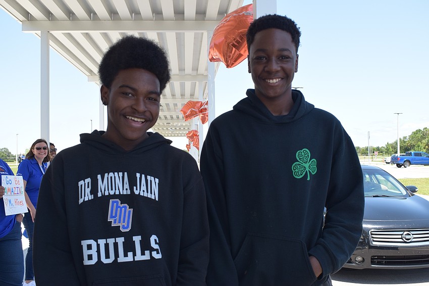 Chancellor and Chauncey Martin, eighth graders at Mona Jain, enjoy the parade and drop off their textbooks.