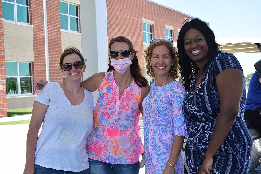 Mona Jain Parent-Teacher Organization members Tara Parker, Kristina Englesberg, Josie Purcell and Temika Lyons enjoy seeing teachers and staff members come for the parade and celebrate the school's eighth graders.