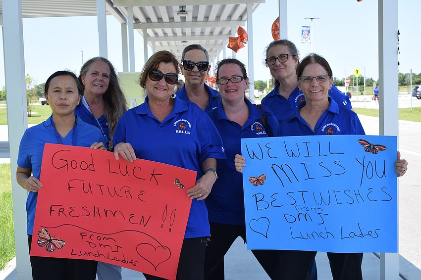 Members of Mona Jain Middle's cafeteria staff congratulate eighth graders.