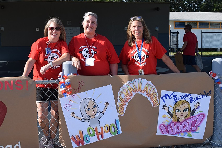 Freedom Elementary fifth grade teachers Danielle McClellan, Jennifer Roberts and Linda Bryan-Beachler show off their Bitmoji posters. Roberts came up with the idea to use Bitmojis after she incorporated them into her e-learning.