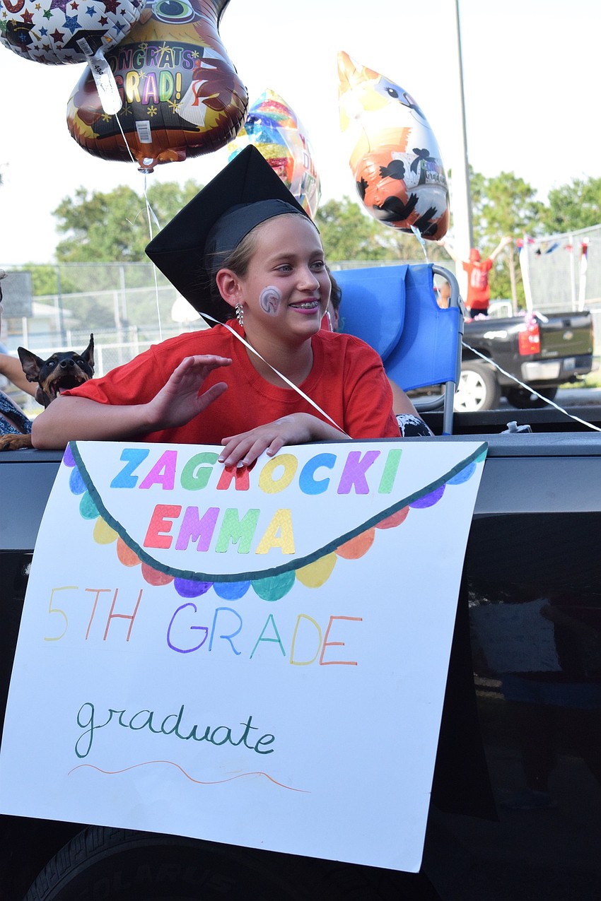 Emma Zagroski, a Freedom Elementary fifth grader, celebrates her graduation. Due to COVID-19, the school couldn't have its annual graduation ceremony, so it had a parade for fifth graders.