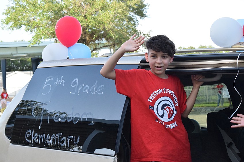 Jose Zuleta-Hernandez, a fifth grader at Freedom Elementary, waves to his teachers.