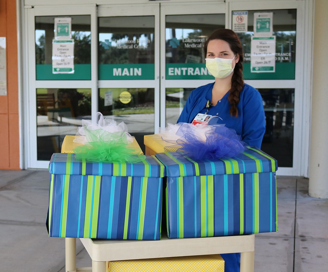 Lakewood Ranch Medical Center nurse Danielle Ford accepts a cake from MTC. Courtesy photo.