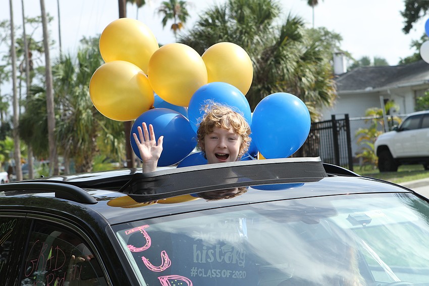 The school's graduating fifth graders waved to cheering staff.