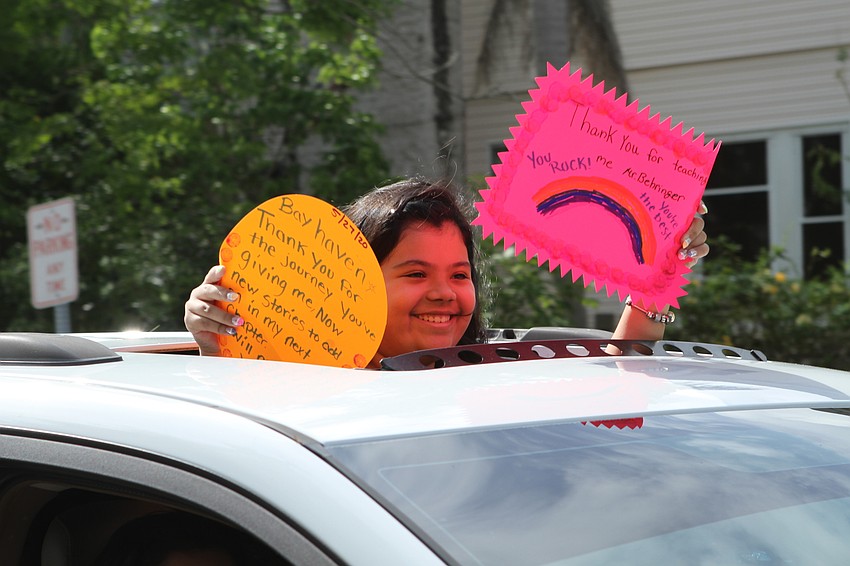 The school's graduating fifth graders waved to cheering staff.