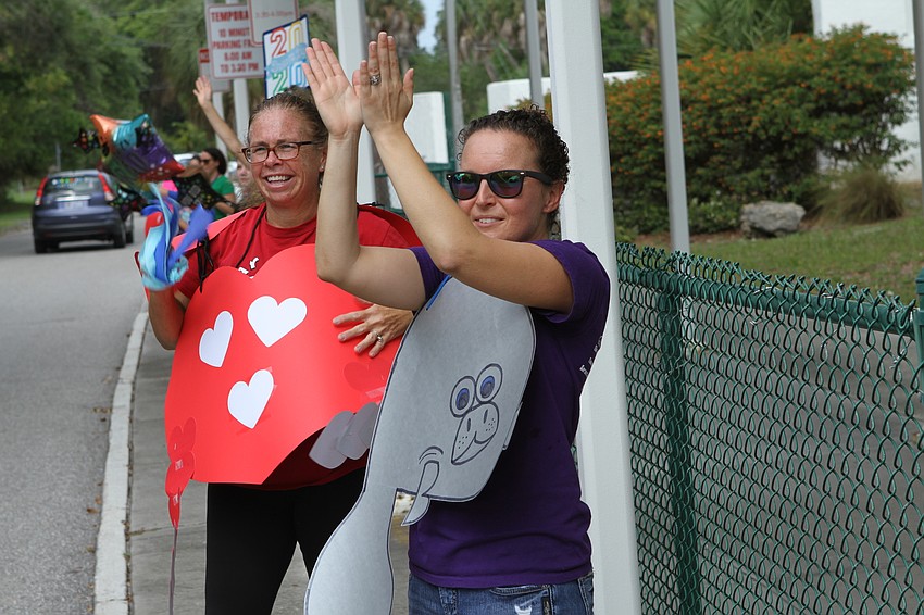 Samantha Morin and Megan Perkins waved on the graduating students.