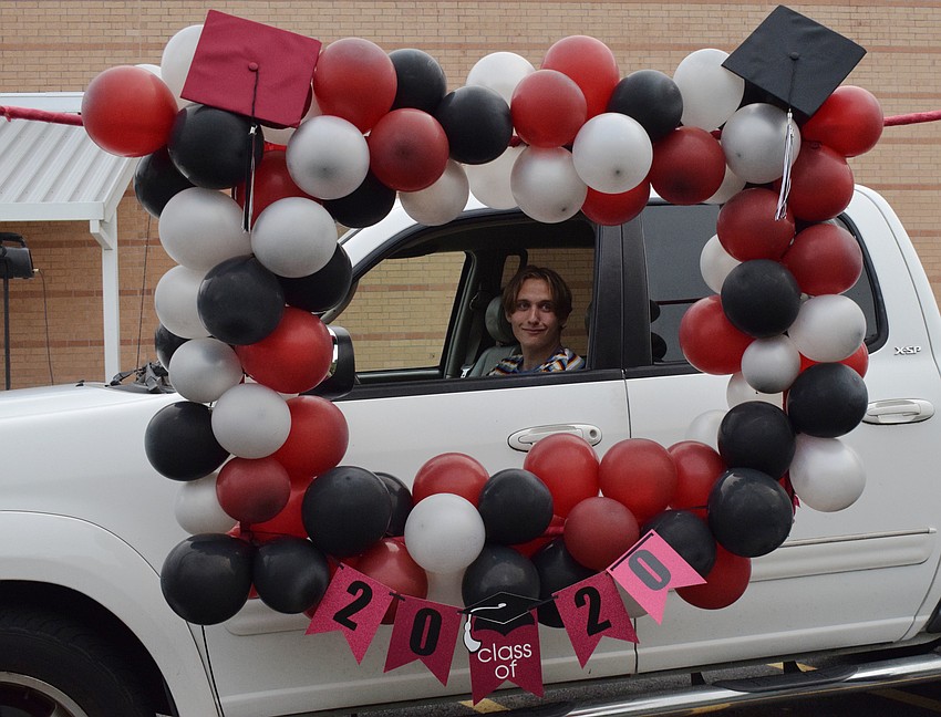 Senior Hunter Knight smiles for a photo before picking up his cap and gown.