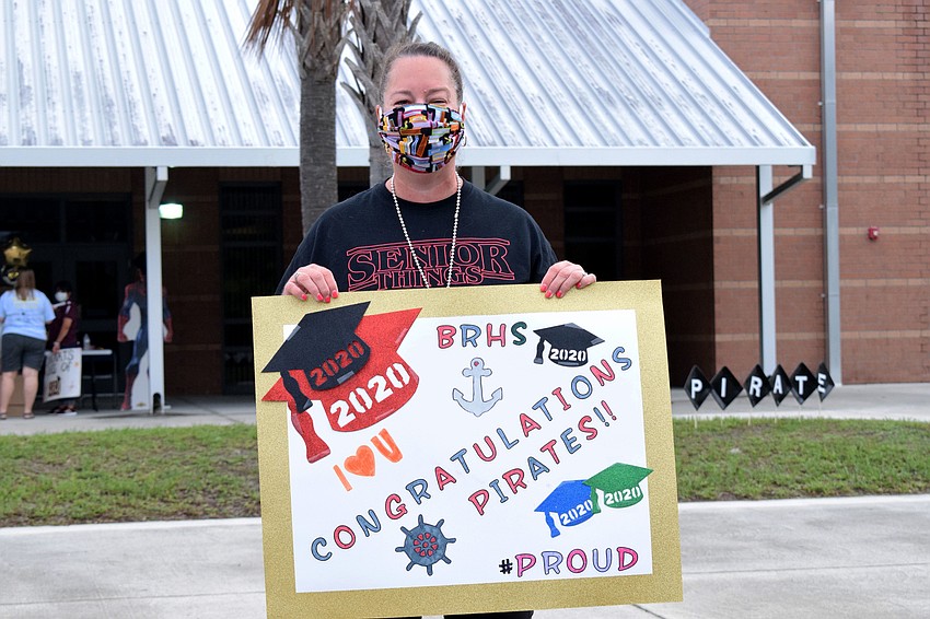 Toni Mullins-Staker, an English teacher, says seeing seniors come by for their caps and gowns is bittersweet. 