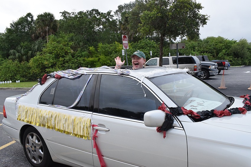 Senior Hannah Badenhorst waves to teachers and staff members are she passes by. 