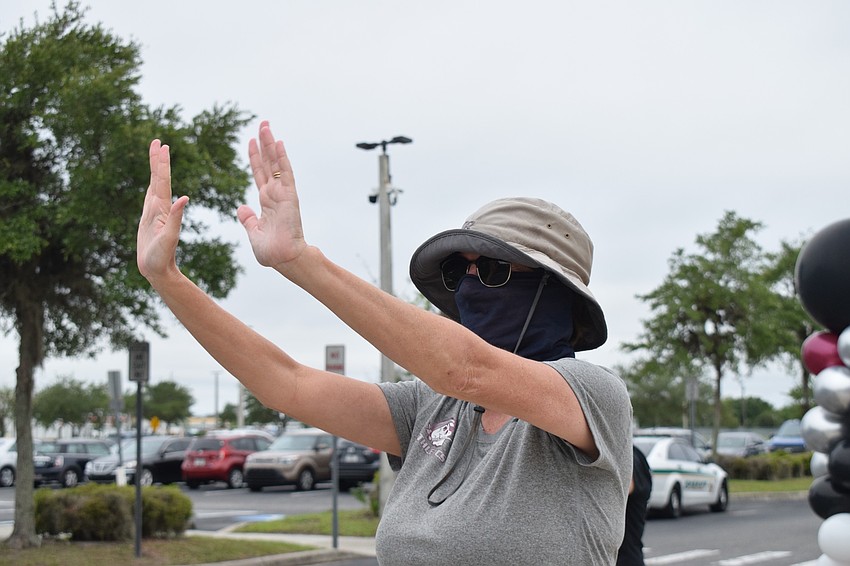 Jenny Elsdon, the language arts department chair, waves to seniors. 