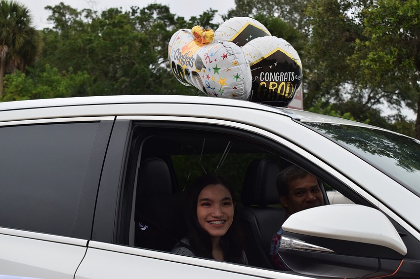 Senior Demi Dionela decorates her car to celebrate her graduation.