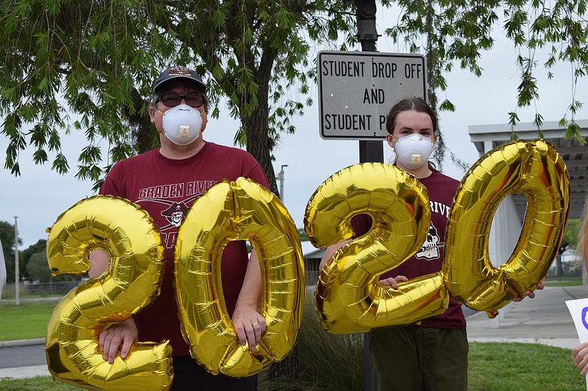 Andrew Wilford and his son Callum hold up 2020 balloons to celebrate the Class of 2020. Andrew Wilford's daughter Madigan is graduating this year.