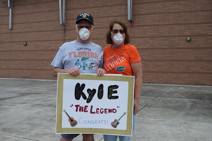 Dick and Marcy Gordon show off the sign they made for their grandson Kyle Wampler, who is graduating this year. 