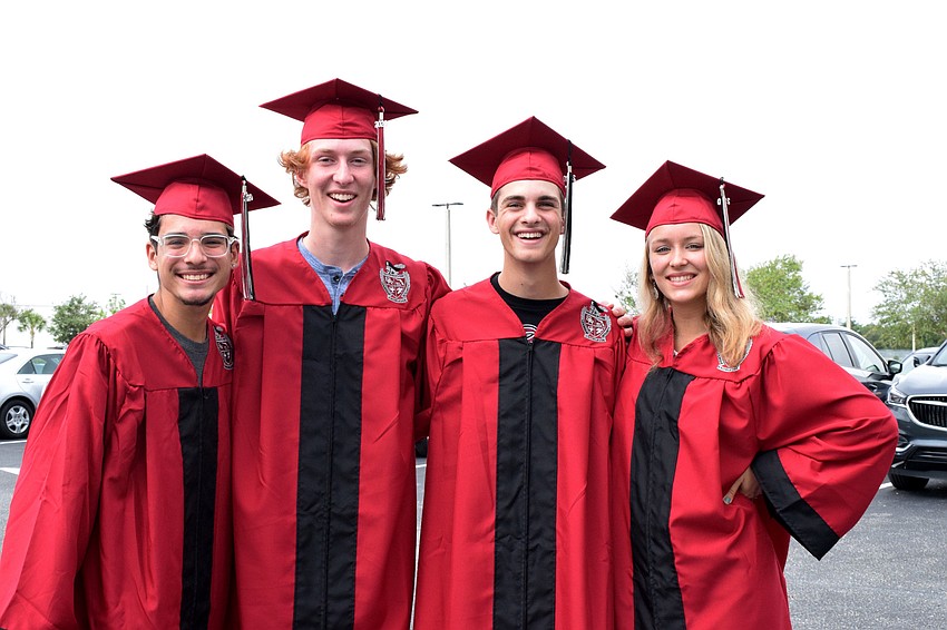 Seniors Juan Brito, Daniel Sipes, Jeremy Rinehart and Cameron Ostenson put on their caps and gowns for the first time. The seniors will put their caps and gowns on again at the July 31 graduation ceremony.