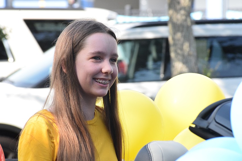Olivia Mueller, an eighth grader, smiles as she finishes the 