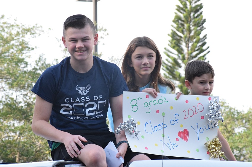 Grant Hutchinson, an eighth grader, celebrates his graduation from Rowlett Middle School with his siblings, Maddie and Jase.
