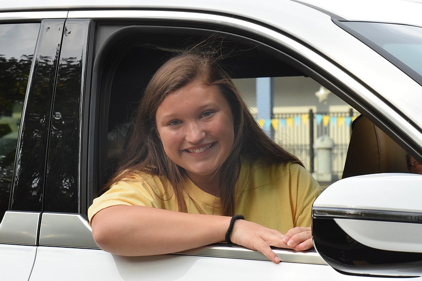 Isabella Silverio, an eighth grader, stops to chat with a teacher during the 