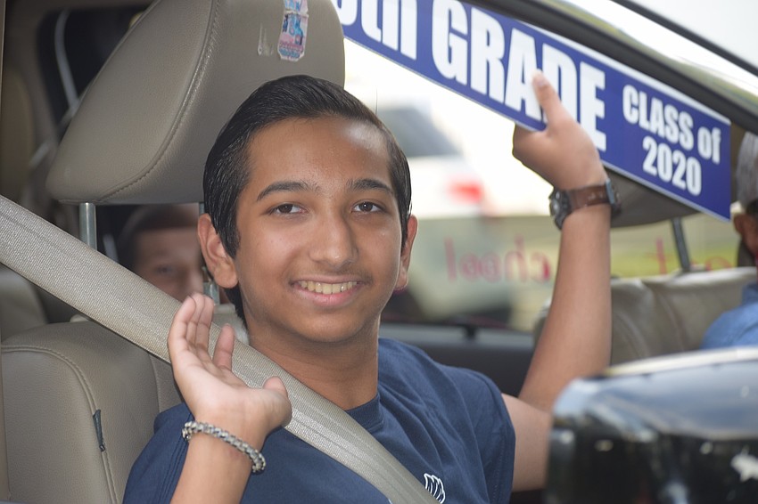 Nathaniel Mahadeo, an eighth grader, waves to his teachers.