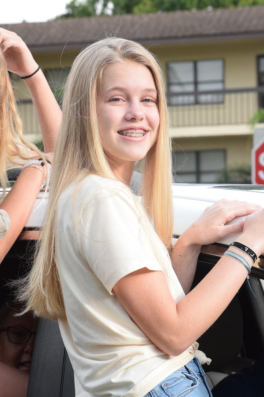 Carly Taylor, an eighth grader, comes through the car loop of the 
