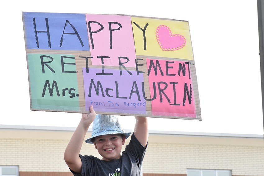 Tom Bergerat, a fifth grader at Robert E. Willis Elementary School, congratulates fifth grade teacher Jacquie McLaurin on her retirement.