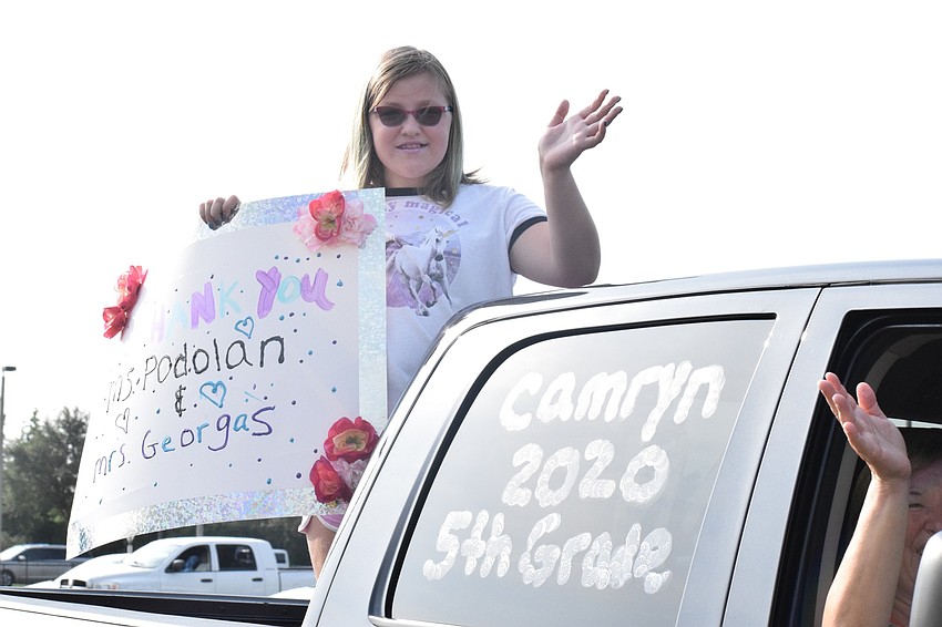 Camryn Duley , a fifth grader at Robert E. Willis Elementary School, thanks her teachers with a handmade sign.
