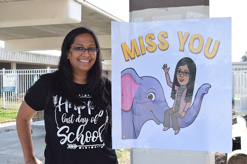 Palak Trivedi, a fifth grade math and science teacher at Gene Witt Elementary, posts her Bitmoji sign for fifth graders to see.