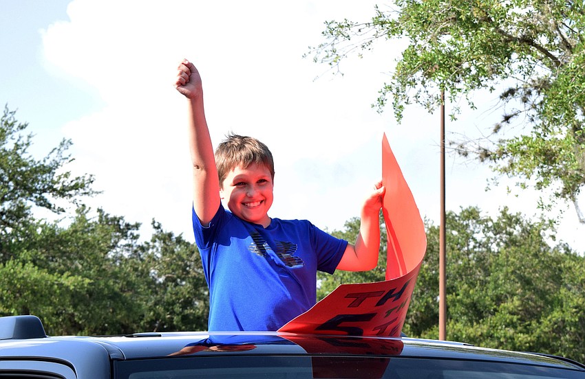 Connor Gerhardt, a fifth grader at Gene Witt Elementary, celebrates his graduation from the school.