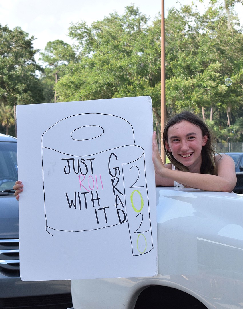 Jaiden Graeff, a fifth grader at Gene Witt Elementary School, makes her teachers laugh with her sign.