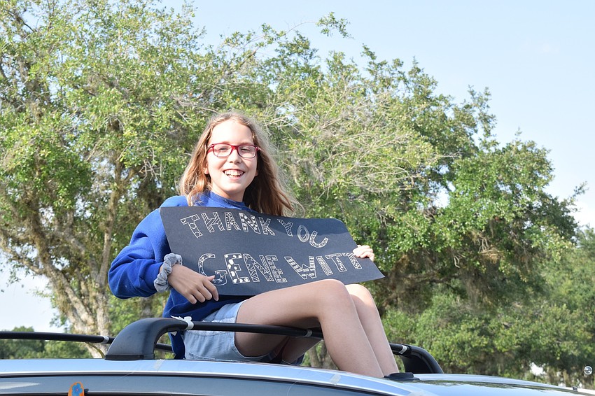 Madelyn Gabriel, a fifth grader at Gene Witt Elementary, thanks the school's teachers and staff members through her sign.