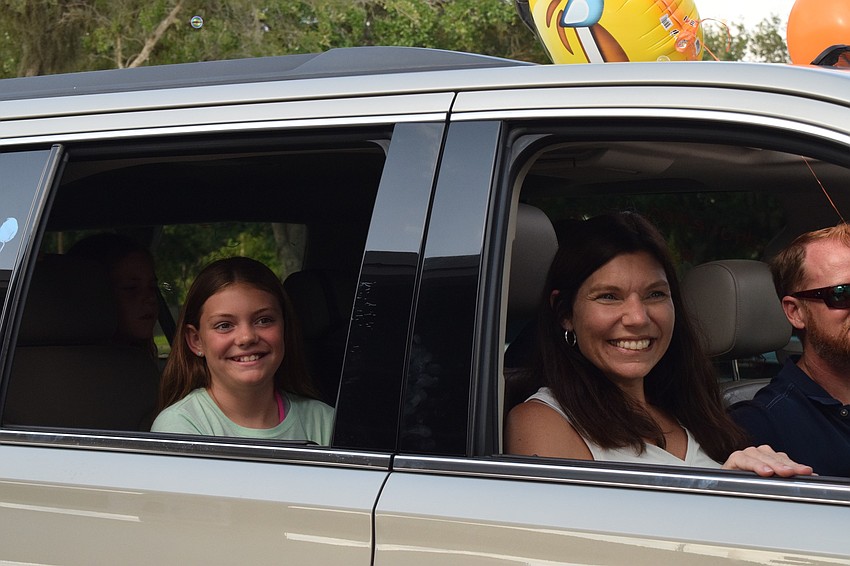 Avery Hackman, a fifth grader at Gene Witt Elementary, and her mother, Marcie, enjoy participating in the fifth grade farewell parade.
