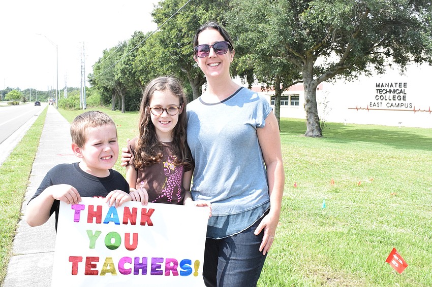 Gene Witt Elementary first grader Jonathan Rosengrant wait to see the Manatee Strong parade with his sister, Alexandria, who is a fifth grader at Gene Witt and his mother, Tiffany.