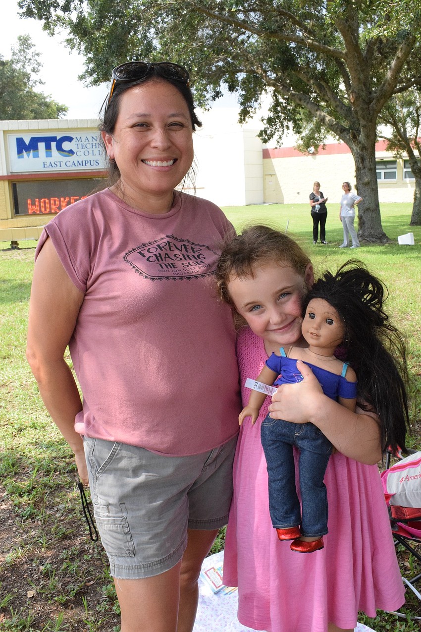 Abigail Williams, a Spanish teacher at Braden River Middle School, and her daughter, Abrianna, who is a kindergartner at Braden River Elementary, are excited to see the Manatee Strong parade.