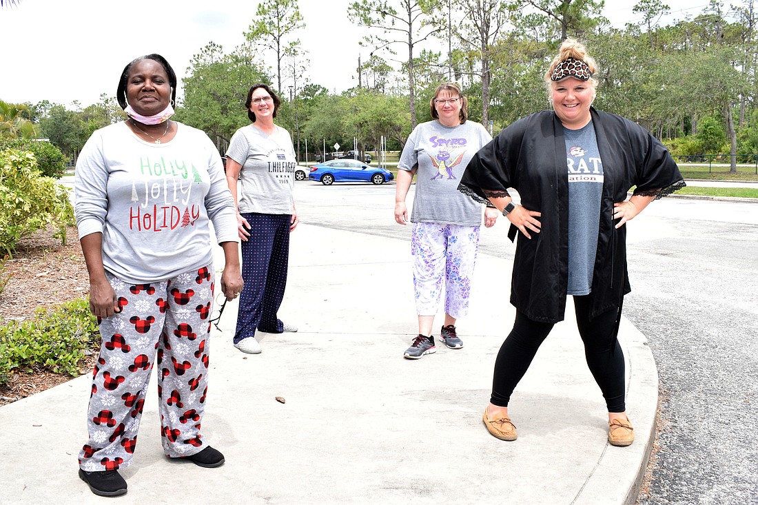 Laura Rowe, Lisa Sheedy, Lisa Andrews and Ashley Dodd, members of Tara Elementary School&#39;s cafeteria staff, wear pajamas while distributing meals. Dodd says the theme days give students something to look forward to every day.