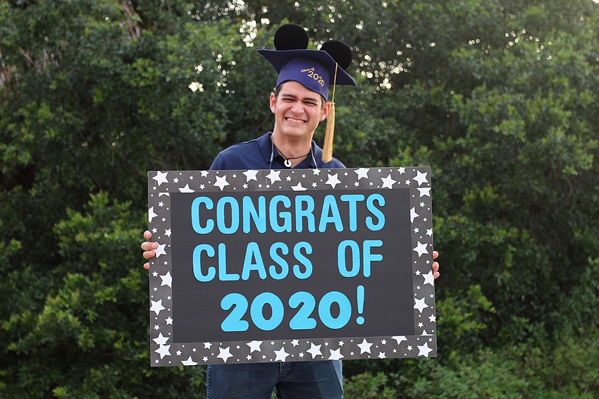 Fernando Azcona-Meza, a math teacher at Out-of-Door Academy's upper school, congratulates seniors during the parade. Courtesy photo.