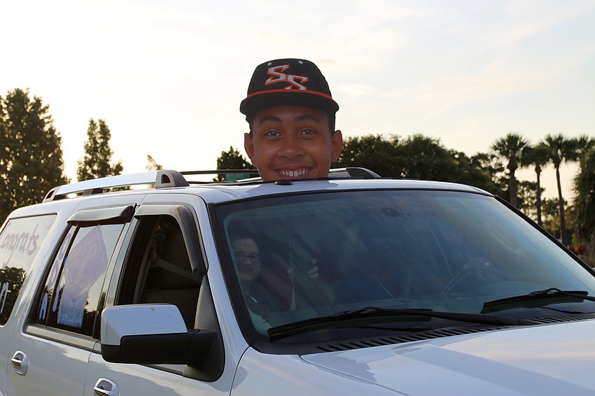 Senior Julien Brown brings an oversized cutout to celebrate his graduation from Out-of-Door Academy. Courtesy photo.