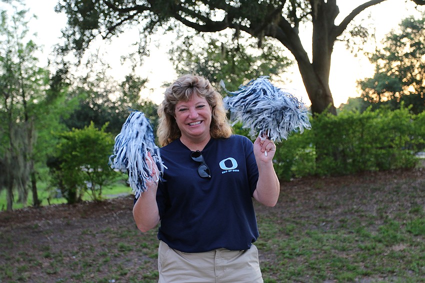 Lisa Cheney, a marine science teacher at Out-of-Door Academy's lower school, cheers for seniors. Courtesy photo.