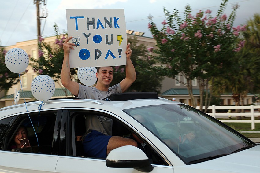 Senior Joey Palmer thanks Out-of-Door Academy teachers and staff members during the school's parade for seniors. Courtesy photo.