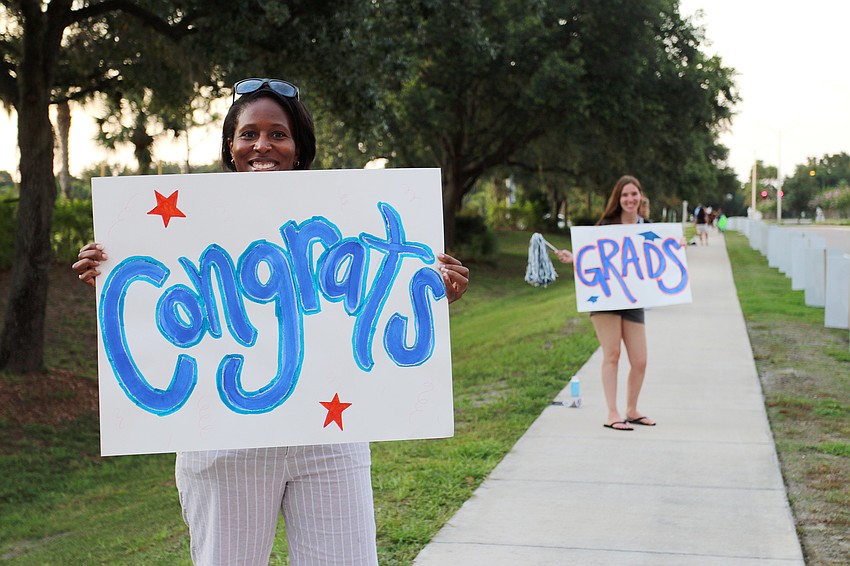 Out-of-Door Academy middle school teachers Kymberli Rivers and Alexandra Lonsdale congratulates seniors as they drive through the parade. Courtesy photo.