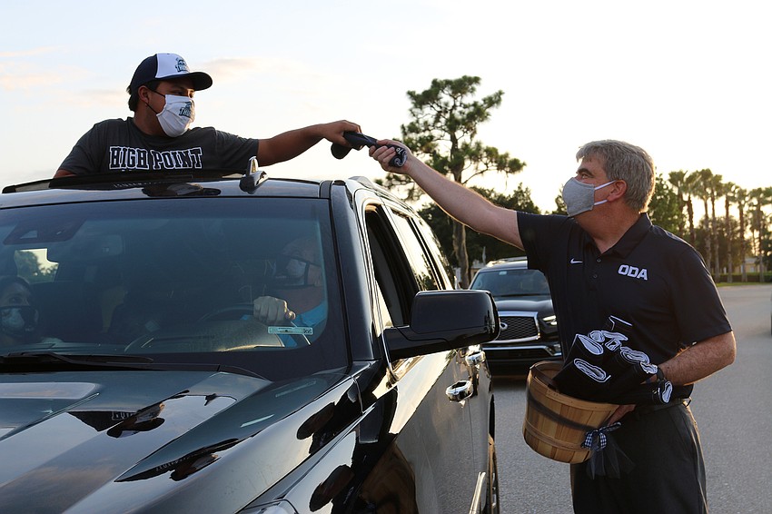 Senior Tomas Giacinti accepts a Class of 2020 keepsake from David Mahler, Out-of-Door Academy's head of school.  Courtesy photo.