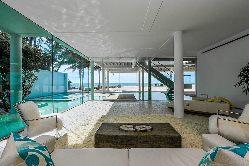 Glass, water, quartz, and shellwork were employed to create a home surrounded by gardens that include a grove of Royal palms, a reflecting pool and bamboo.