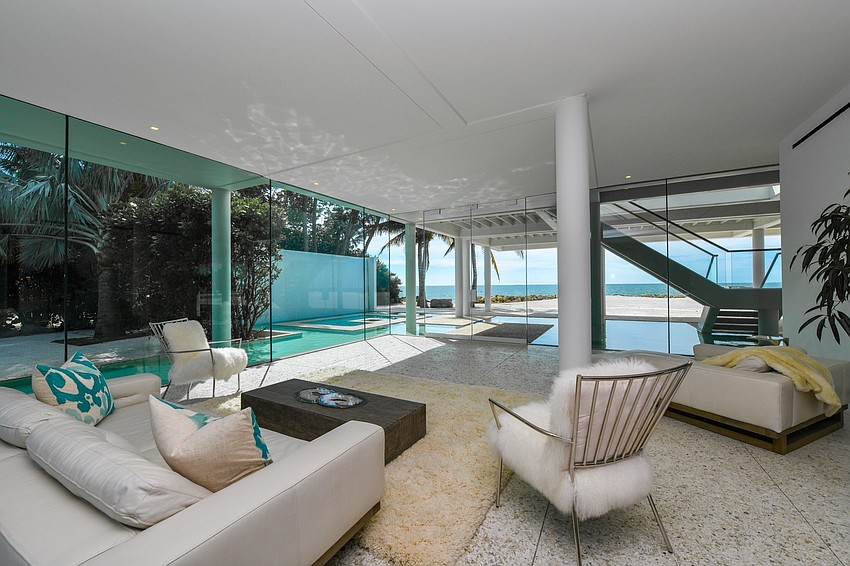 Glass, water, quartz, and shellwork were employed to create a home surrounded by gardens that include a grove of Royal palms, a reflecting pool and bamboo.