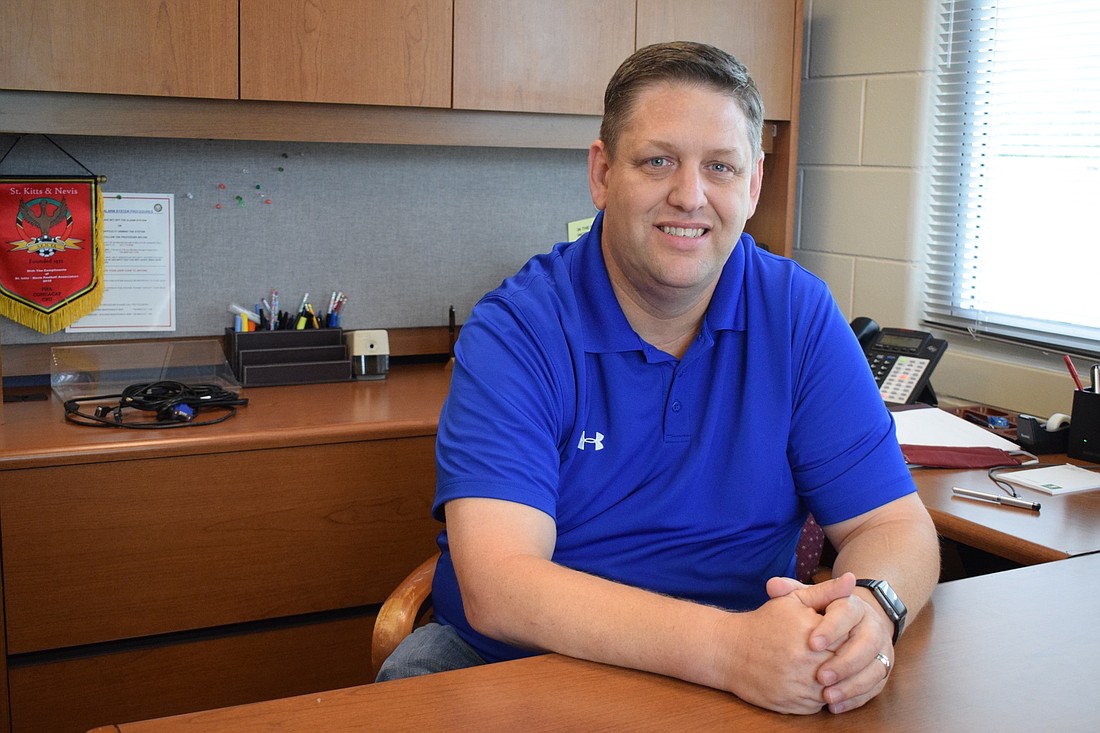 Scott Cooper, the new principal at R. Dan Nolan Middle School, settles into his new office. He hopes to expand the performing arts and career and technical education programs at the school in the future.