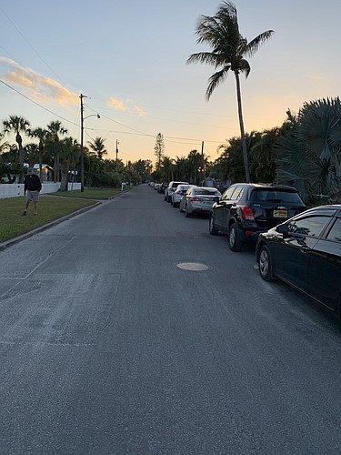 Cars parked on the side of the street in the Longbeach Villages neighborhood of Longboat Key.