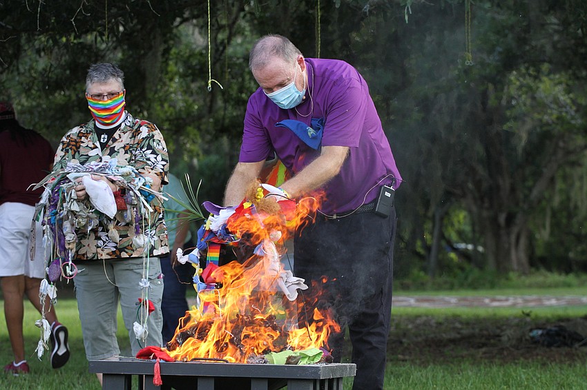 Pastor Tony Viglione put the prayer ties onto the fire.