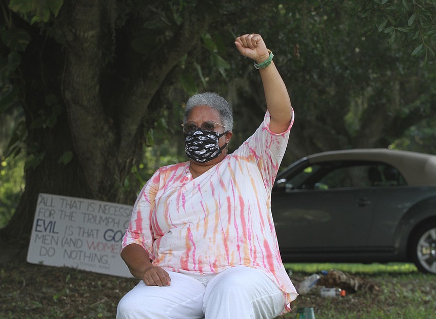 Candy Holmes held her fist up in solidarity.