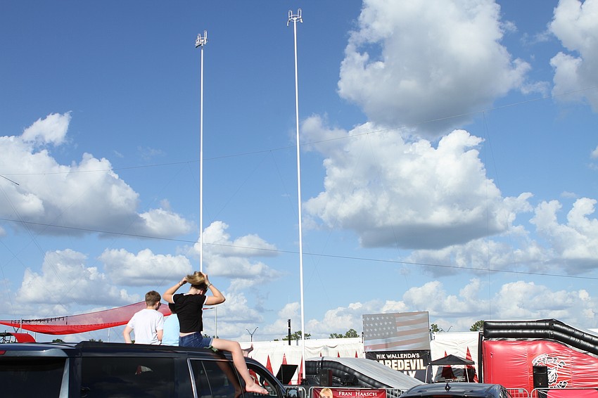 Attendees sat in their cars or lawn chairs for the show.