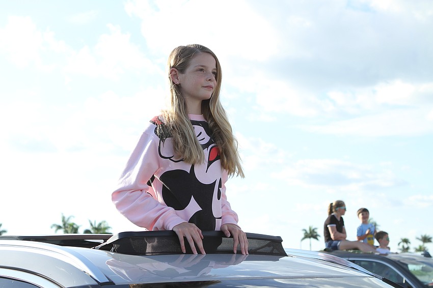 Lilly Wheler looked on from the car's roof.