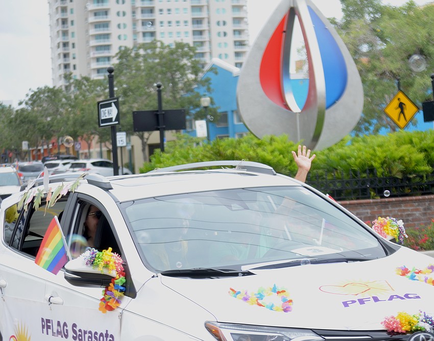 The parade moves through the traffic circle at Orange Avenue.