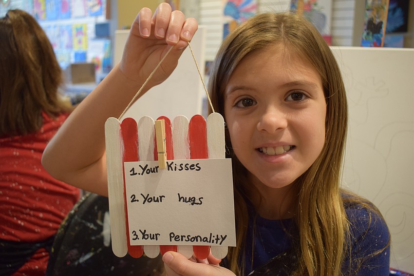 Parrish 9-year-old Maddison Butz shows off the message she created for her dad, Jon Butz.